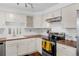 Bright kitchen featuring white cabinetry, butcher block countertops, and stainless steel appliances at 4544 W 65Th Ave, Arvada, CO 80003