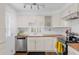 Bright kitchen featuring white cabinetry, butcher block countertops, and stainless steel appliances at 4544 W 65Th Ave, Arvada, CO 80003