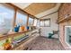 Bright sunroom with shelves, windows, and gravel flooring, perfect for gardening or enjoying the natural light at 4544 W 65Th Ave, Arvada, CO 80003