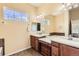 Bathroom features dual sinks with granite counters and ample natural light at 16550 Antero Cir, Broomfield, CO 80023
