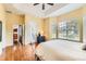 Bedroom with hardwood flooring, large windows, and access to outdoor patio at 16550 Antero Cir, Broomfield, CO 80023