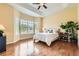 Bright bedroom features hardwood floors, a large bay window, and neutral decor at 16550 Antero Cir, Broomfield, CO 80023