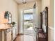 Inviting entryway featuring wood floors, a decorative cabinet and mirror, and a coat rack at 16550 Antero Cir, Broomfield, CO 80023