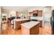 Spacious kitchen featuring a central island, wood cabinetry and modern appliances at 16550 Antero Cir, Broomfield, CO 80023