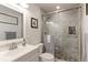 Modern bathroom boasting a glass-enclosed shower, stylish tiling, and a well-lit vanity area at 13713 Raritan Ln, Broomfield, CO 80023