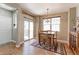 Bright dining area features wood floors, a modern light fixture, and sliding glass doors to the outside at 13713 Raritan Ln, Broomfield, CO 80023
