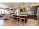 Stylish kitchen with a large center island, hardwood floors, and an open design connecting to the living area at 13713 Raritan Ln, Broomfield, CO 80023