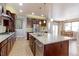 Bright kitchen boasts a large island, stainless steel appliances, and a seamless transition to the dining area at 13713 Raritan Ln, Broomfield, CO 80023