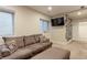 Cozy living room featuring comfortable seating, natural light, and a wall-mounted TV at 13713 Raritan Ln, Broomfield, CO 80023