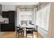 Chic dining area featuring a round table, modern lighting, and large windows with natural light at 3927 N Cook St, Denver, CO 80205