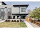 Stylish gray brick home featuring modern design, black trim, and well-maintained landscaping at 3927 N Cook St, Denver, CO 80205