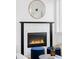 Close-up of the fireplace with marble tile, black trim, and modern fireplace insert at 3927 N Cook St, Denver, CO 80205