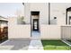 Charming home entrance with a modern black door and inviting walkway, enhanced by well-maintained landscaping and privacy fences at 3927 N Cook St, Denver, CO 80205