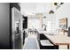 Modern kitchen with island, stainless steel refrigerator, and dining area nearby at 3927 N Cook St, Denver, CO 80205