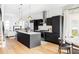 Open-concept kitchen with sleek black cabinetry, stainless steel appliances, and view to the living room at 3927 N Cook St, Denver, CO 80205