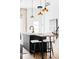 Kitchen island with seating and view into living room area with fireplace. Modern lighting fixtures overhead at 3927 N Cook St, Denver, CO 80205