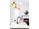 Bright kitchen featuring a white island, black faucet, and view to the fireplace and living room at 3927 N Cook St, Denver, CO 80205