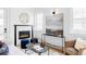 Cozy living room features a marble fireplace, round mirror, and stylish decor at 3927 N Cook St, Denver, CO 80205