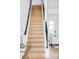 Bright staircase features light wood steps with a black handrail and white walls at 3927 N Cook St, Denver, CO 80205