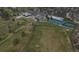 A bird's eye view of a neighborhood golf course featuring a restaurant, tennis courts and well-manicured lawns at 6396 Twin Lakes Rd, Boulder, CO 80301