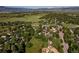 Expansive aerial view showcasing the community surrounded by lush greenery, and mountain views at 6396 Twin Lakes Rd, Boulder, CO 80301