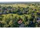 Aerial view of a beautiful home nestled in a lush green landscape with trees and open fields at 6396 Twin Lakes Rd, Boulder, CO 80301
