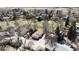 A panoramic aerial shot of a residential neighborhood showcasing mature trees, green spaces, and a glimpse of the surrounding landscape at 6396 Twin Lakes Rd, Boulder, CO 80301