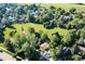 Overhead view of the home in a lush, green neighborhood with mature trees and open space at 6396 Twin Lakes Rd, Boulder, CO 80301