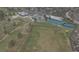 Aerial view of community golf course, tennis courts, and large clubhouse at 6396 Twin Lakes Rd, Boulder, CO 80301