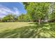 Green backyard with manicured lawn and mature trees offering plenty of shade at 6396 Twin Lakes Rd, Boulder, CO 80301