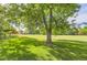 Expansive grassy backyard with mature shade trees at 6396 Twin Lakes Rd, Boulder, CO 80301