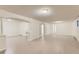 Spacious finished basement with recessed lighting, white columns, and gray wood-look floors at 6396 Twin Lakes Rd, Boulder, CO 80301