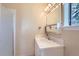 Small bathroom featuring a white vanity and sink, a mirror, and a window at 6396 Twin Lakes Rd, Boulder, CO 80301