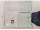 Bright white tiled bathroom with tub and glass door and a towel bar at 6396 Twin Lakes Rd, Boulder, CO 80301