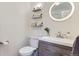 Modern bathroom with stylish shelves, a round mirror, and a vessel sink at 6396 Twin Lakes Rd, Boulder, CO 80301