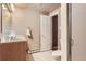Bathroom featuring a vanity, toilet, and shower, with a view into the hall at 6396 Twin Lakes Rd, Boulder, CO 80301
