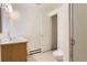 Bathroom with neutral-toned tile, wooden cabinets and standard toilet and fixtures at 6396 Twin Lakes Rd, Boulder, CO 80301