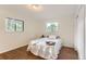 Cozy bedroom with wood floors, two windows, and ample natural light at 6396 Twin Lakes Rd, Boulder, CO 80301