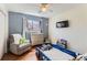 Bright bedroom featuring hardwood floors, toys, and a window at 6396 Twin Lakes Rd, Boulder, CO 80301
