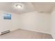 Neutral bedroom with light wood-look floors, a window and baseboard heaters at 6396 Twin Lakes Rd, Boulder, CO 80301