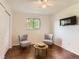 Bedroom with wood floors, a ceiling fan and two chairs and side table at 6396 Twin Lakes Rd, Boulder, CO 80301