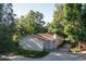 Charming single-story home featuring a private, wooded lot with a long concrete driveway at 6396 Twin Lakes Rd, Boulder, CO 80301