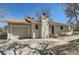 Charming single-story home with a chimney, attached garage, and a quaint blue front door at 6396 Twin Lakes Rd, Boulder, CO 80301