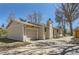 Well-maintained single-story home with an attached garage, chimney, and a tidy, inviting front yard at 6396 Twin Lakes Rd, Boulder, CO 80301