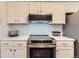 A well-equipped kitchen featuring modern appliances and bright white cabinetry at 6396 Twin Lakes Rd, Boulder, CO 80301