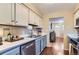 Bright kitchen featuring updated appliances, modern countertops, and stylish blue and white cabinets at 6396 Twin Lakes Rd, Boulder, CO 80301