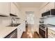 Bright kitchen with white cabinets, stainless steel appliances, and laminate floors at 6396 Twin Lakes Rd, Boulder, CO 80301