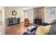 Inviting living room featuring a stone fireplace, hardwood floors, and stylish furnishings at 6396 Twin Lakes Rd, Boulder, CO 80301