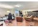Basement living room with a gaming setup, TV, and comfortable leather seating at 6396 Twin Lakes Rd, Boulder, CO 80301