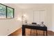 Office space features hardwood floors and a large window for natural light at 6396 Twin Lakes Rd, Boulder, CO 80301